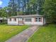 Charming single-story home with a well-manicured lawn and freshly painted white exterior at 2478 Graywall St, Atlanta, GA 30344