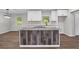 Close up of a center kitchen island featuring gray toned stone top and a breakfast bar at 2478 Graywall St, Atlanta, GA 30344