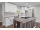 Updated kitchen features white cabinetry, granite counters, and a center island with cooktop at 2478 Graywall St, Atlanta, GA 30344
