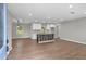 Open-concept kitchen featuring modern white cabinetry, granite countertops, and a rustic center island at 2478 Graywall St, Atlanta, GA 30344