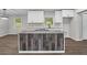 Open-concept kitchen boasts an island with seating, modern white cabinetry, and stainless steel appliances at 2478 Graywall St, Atlanta, GA 30344