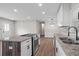 Open kitchen showcasing new appliances, granite counters, white cabinets, and hardwood floors at 2478 Graywall St, Atlanta, GA 30344