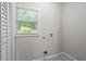 A laundry room featuring utility connections, closet, and natural light from window at 2478 Graywall St, Atlanta, GA 30344