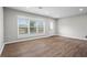Open-concept living area with modern hardwood floors and large windows at 2478 Graywall St, Atlanta, GA 30344
