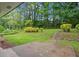 Spacious backyard with lush greenery, landscaping, and a patio, perfect for outdoor relaxation and entertainment at 2478 Graywall St, East Point, GA 30344