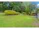 Lush green backyard with mature trees and well-maintained lawn offers a serene and private outdoor space at 2478 Graywall St, East Point, GA 30344