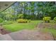 Expansive backyard features a patio area, mature trees, and lush landscaping providing a private outdoor retreat at 2478 Graywall St, East Point, GA 30344