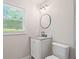 Bathroom featuring a vanity and toilet with a window for natural light at 2478 Graywall St, East Point, GA 30344