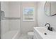 Clean bathroom featuring white tile and modern fixtures at 2478 Graywall St, East Point, GA 30344
