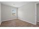 A modern bedroom with hardwood style floors with a large window at 2478 Graywall St, East Point, GA 30344