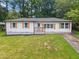 Inviting single-story house boasting fresh paint, wooden shutters, and a well-maintained front yard and sidewalk at 2478 Graywall St, East Point, GA 30344