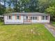 Charming one-story home with a well-maintained lawn, brown shutters, and a light blue front door at 2478 Graywall St, East Point, GA 30344