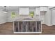 Detailed view of kitchen island with granite countertops and a unique wood panel design at 2478 Graywall St, East Point, GA 30344