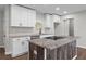 Kitchen featuring granite countertops, modern white cabinets, a central island, and stainless appliances at 2478 Graywall St, East Point, GA 30344