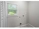 Bright laundry room with ample natural light, laundry hook ups and built-in closet for storage at 2478 Graywall St, East Point, GA 30344