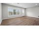 Bright and airy living room with new flooring, a large window, and a back door at 2478 Graywall St, East Point, GA 30344