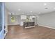 Open-concept living space with wood-look floors, recessed lighting, and a combined kitchen at 2478 Graywall St, East Point, GA 30344
