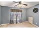 Neutral bedroom features carpet, ceiling fan, and window with silver curtains at 2733 Cedar Tree Ln, Ellenwood, GA 30294