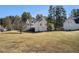 View of the home's exterior with a large yard and mature trees at 2733 Cedar Tree Ln, Ellenwood, GA 30294