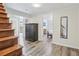 Basement entryway featuring wood stairs, stylish flooring, and black cabinet at 767 Smithstone Se Rd, Marietta, GA 30067