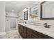 Bright bathroom featuring a double vanity with marble countertop and a tiled walk-in shower with dual shower heads at 767 Smithstone Se Rd, Marietta, GA 30067