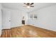 This primary bedroom features hardwood floors, a ceiling fan, and an ensuite bathroom with granite countertops at 767 Smithstone Se Rd, Marietta, GA 30067