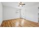 A minimalist bedroom features wood floors, closet, and a ceiling fan; bathed in natural light at 767 Smithstone Se Rd, Marietta, GA 30067