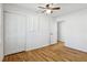 Bedroom features new hardwood floors, a ceiling fan, double closets, and white painted walls at 767 Smithstone Se Rd, Marietta, GA 30067