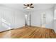 Bright bedroom featuring hardwood floors, a closet, neutral walls, and a view to an ensuite bathroom at 767 Smithstone Se Rd, Marietta, GA 30067