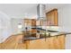 A warm kitchen featuring wooden cabinets, stainless steel appliances, and a breakfast bar with granite countertop at 767 Smithstone Se Rd, Marietta, GA 30067