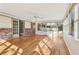 Bright sunroom with a ceiling fan, brick accent, and hardwood floors at 767 Smithstone Se Rd, Marietta, GA 30067