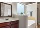 Bright bathroom featuring a bathtub, a large window for natural light, and a stylish vanity at 821 Bufflehead Ct, Stockbridge, GA 30281