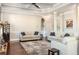 Bright living room with tray ceilings, recessed lighting, and neutral-toned furniture at 821 Bufflehead Ct, Stockbridge, GA 30281