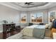 Spacious main bedroom featuring tray ceiling, hardwood floors, and plenty of natural light at 821 Bufflehead Ct, Stockbridge, GA 30281