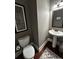 Charming powder room featuring pedestal sink, wood floors, and decorative wall art at 821 Bufflehead Ct, Stockbridge, GA 30281