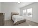 Neutral bedroom with a large bed, side table and plentiful natural light from large windows at , Dunwoody, GA 30338