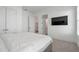 Well-lit bedroom featuring neutral carpet, access to a walk-in closet and bathroom, and a mounted television at , Dunwoody, GA 30338