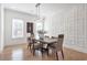 Dining room with decorative wall, modern lighting, hardwood floors, and a dining table with seating for six at , Dunwoody, GA 30338