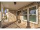 Charming covered front porch featuring brick flooring, white columns, and large windows at , Dunwoody, GA 30338