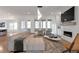 Elegant living room featuring a fireplace, modern lighting, and a seamless transition to the sunroom at , Dunwoody, GA 30338