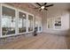 Covered patio with brick accents, hardwood flooring, ceiling fan, and seamless transition to the home's interior at , Dunwoody, GA 30338