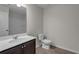 Bathroom featuring a tub/shower combo, a white toilet, and a dark vanity with sink at 1848 Laurel Green Way, Atlanta, GA 30344