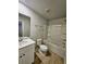 Bright bathroom featuring a shower-tub combo, wood-look flooring and a white vanity with a sink at 2510 Polaris Sw Way, Atlanta, GA 30331