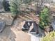 Aerial view of a cozy one-story home, showcasing the roof, yard, and surrounding trees at 2577 Twin Oaks Sw Dr, Marietta, GA 30064