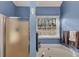 Bathroom featuring a soaking tub, glass enclosed shower and bright natural light at 2577 Twin Oaks Sw Dr, Marietta, GA 30064