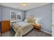 Carpeted bedroom featuring a large window and a tufted headboard at 2577 Twin Oaks Sw Dr, Marietta, GA 30064