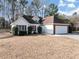 Charming single Gathering home with an attached two car garage and manicured bushes at 2577 Twin Oaks Sw Dr, Marietta, GA 30064