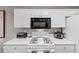 Efficient kitchen design with white cabinets and appliances at 2577 Twin Oaks Sw Dr, Marietta, GA 30064