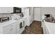 Efficient kitchen design with white appliances and tiled floors at 2577 Twin Oaks Sw Dr, Marietta, GA 30064