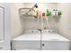 Functional laundry area with modern washing machines and shelving at 2577 Twin Oaks Sw Dr, Marietta, GA 30064